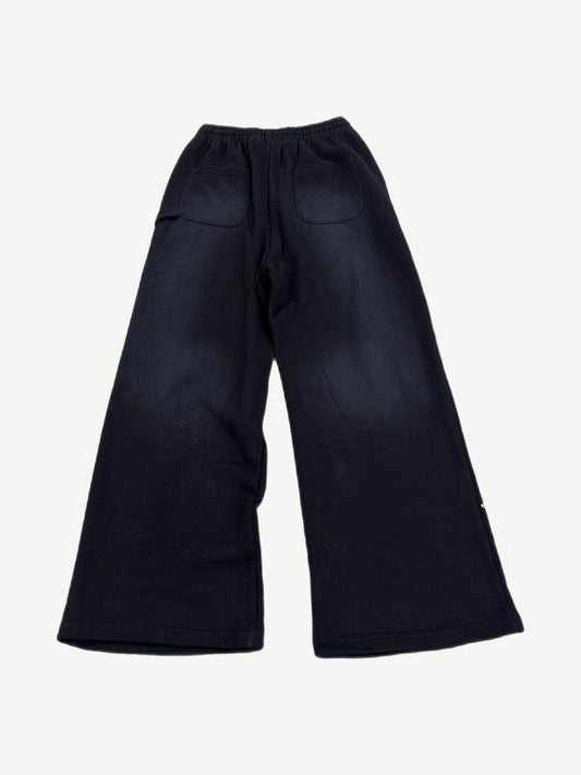 Back view of HMDD black flared sweatpants with patch pockets and faded fabric finish