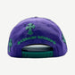 Chrome Hearts purple cap rear view with green cross patches and embroidered Chrome Hearts script above adjustable strap