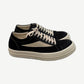 Rick Owens DRKSHDW Vintage low sneakers in black canvas with cream suede side flash and chunky off-white rubber sole.