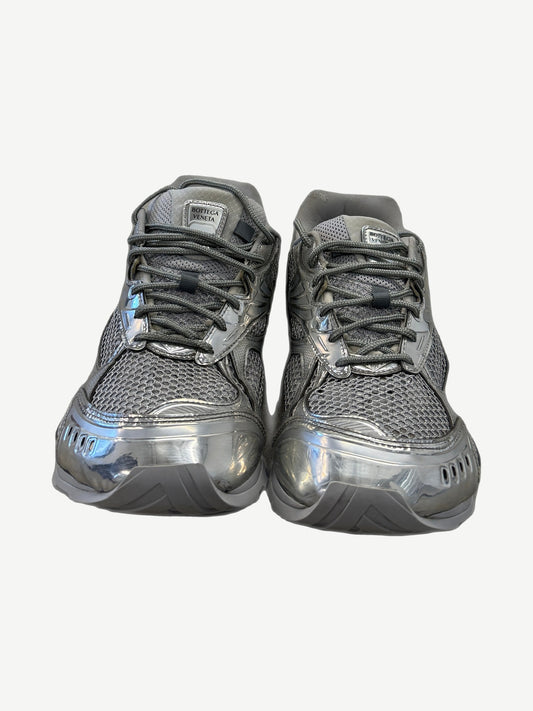 Bottega Veneta Orbit sneakers front pair view with silver metallic uppers, mesh inserts and woven label tongue