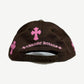 Chrome Hearts brown CH baseball cap side angle, curved brim and pink cross patch detail