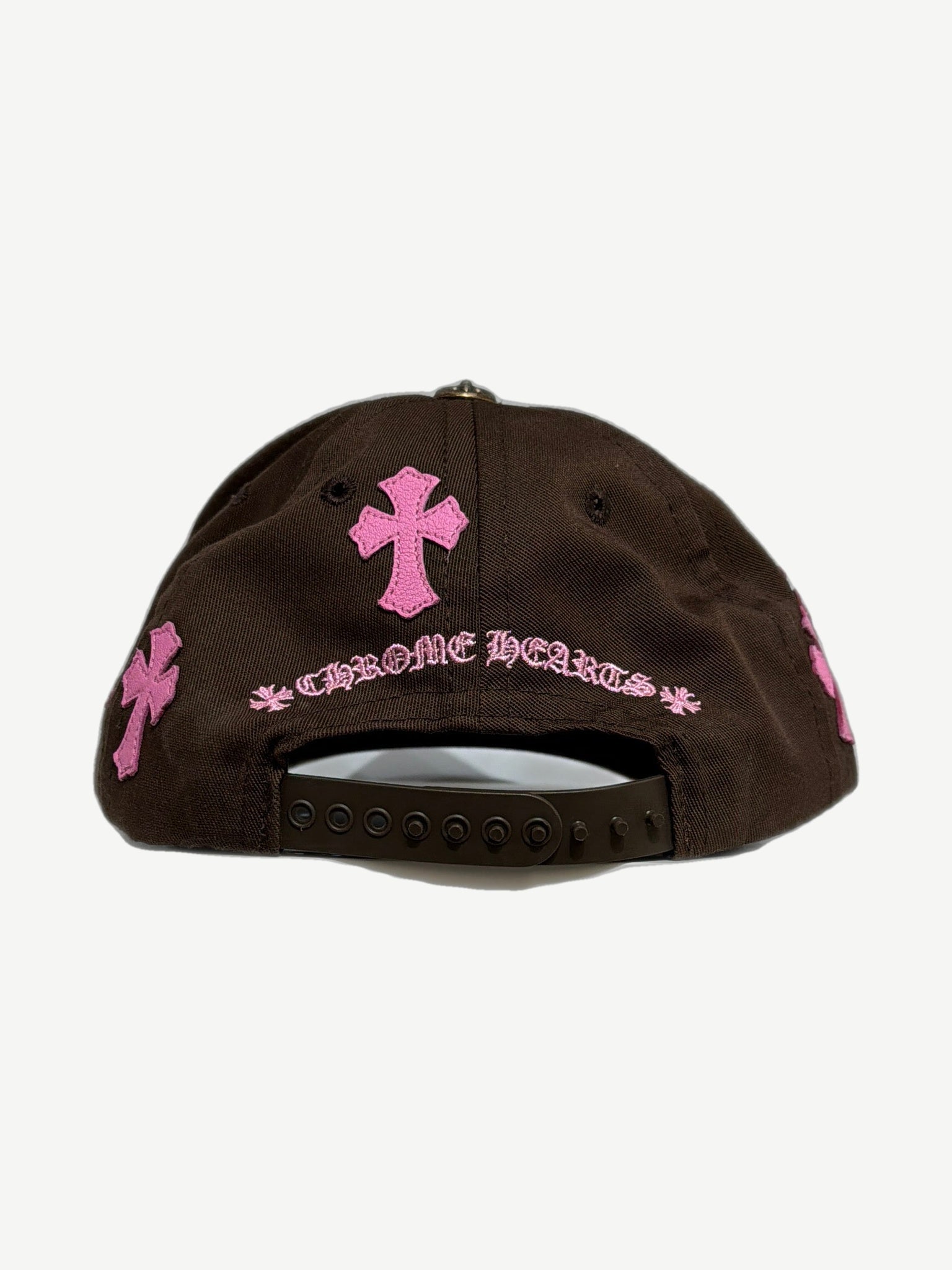 Chrome Hearts brown CH baseball cap side angle, curved brim and pink cross patch detail