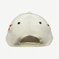 HMDD cream Memories snapback hat angled side view showing orange flame embroidery and curved brim.
