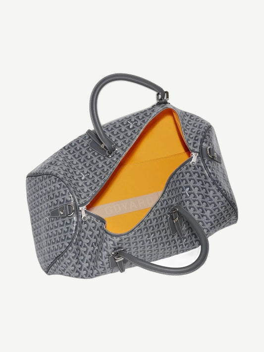 Interior view of Goyard Boston 50 duffle showing bright yellow lining and gray chevron canvas exterior