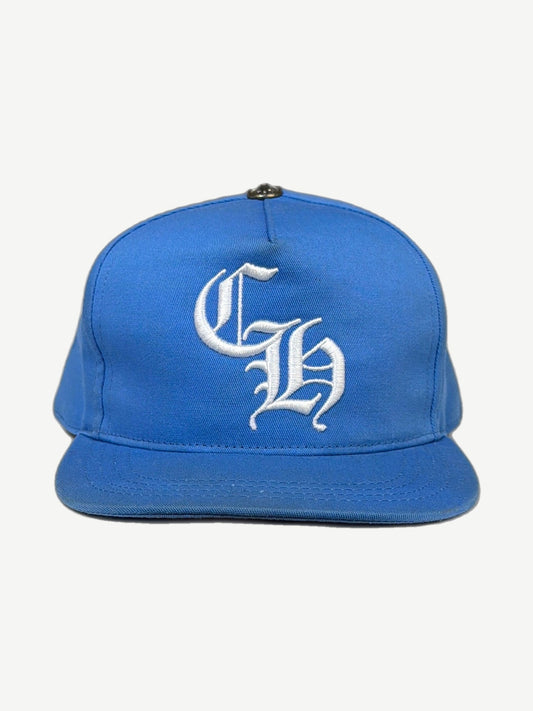 Chrome Hearts light blue baseball cap front with white Old English CH embroidery and silver cross stud.