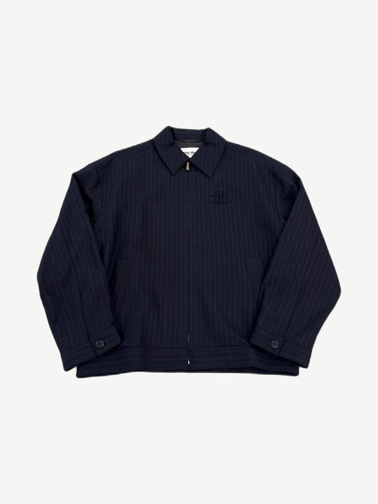 Miu Miu navy pinstripe blouson jacket front, full zip with point collar and tonal embossed miu miu chest logo.