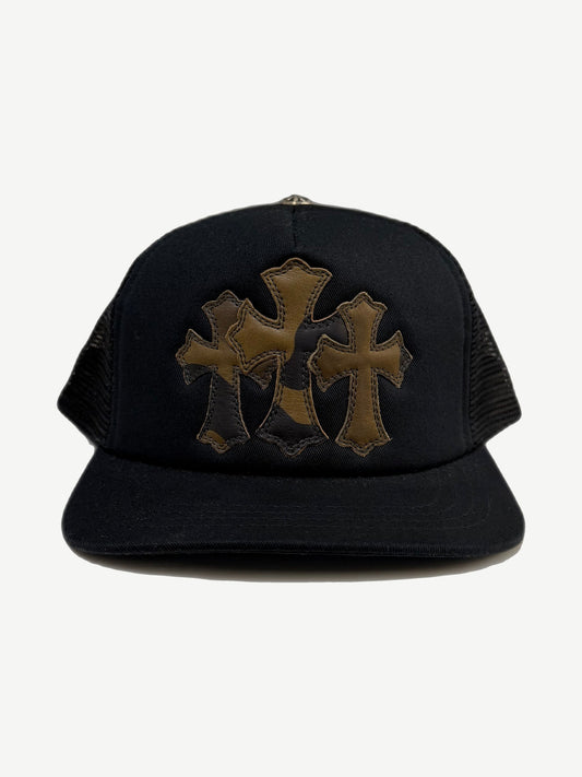 Chrome Hearts black trucker hat with triple leather cross patches in olive camo tones across the front panel