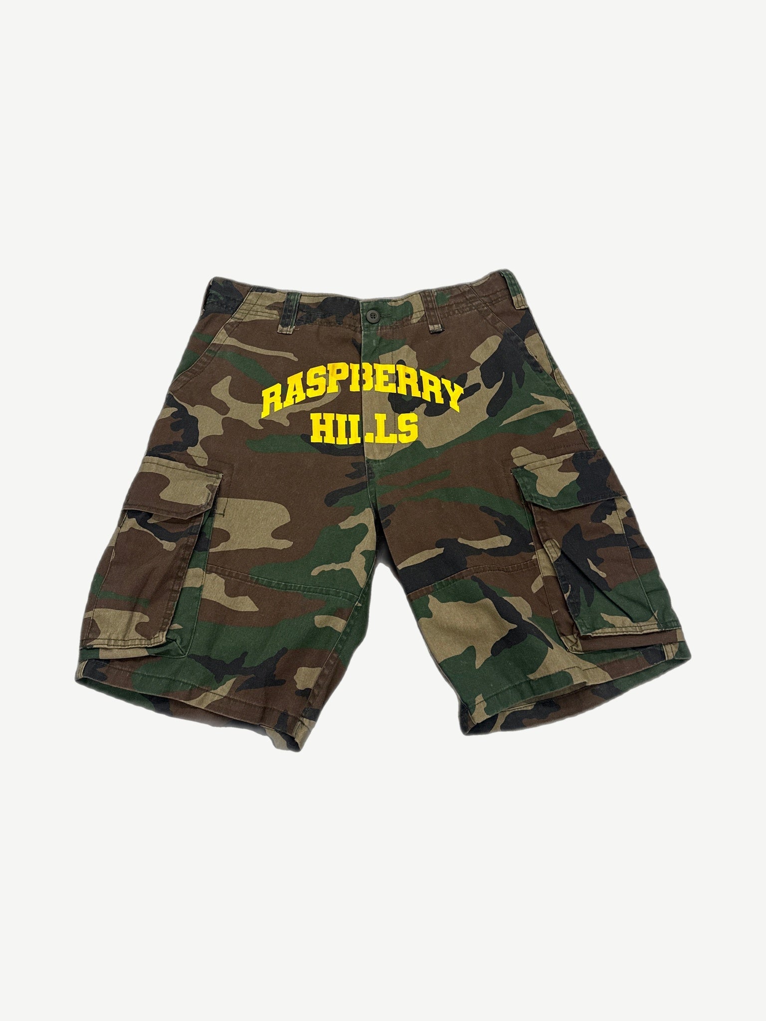 GV Gallery Raspberry Hills woodland camo cargo shorts front with yellow varsity arch logo print.