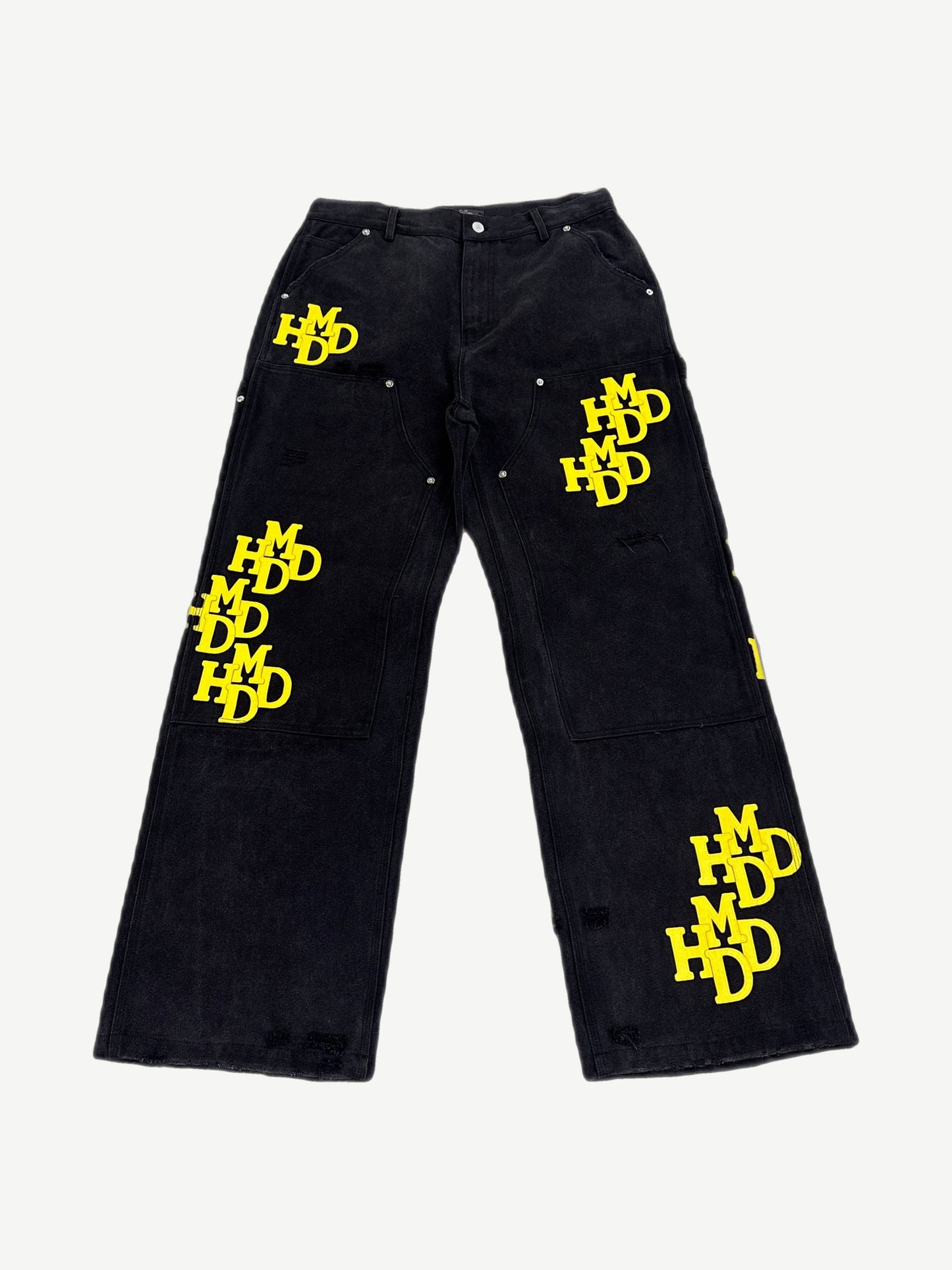 Happy Memories Don't Die HMDD black carpenter pants with yellow patches, utility loops and tool pockets, front