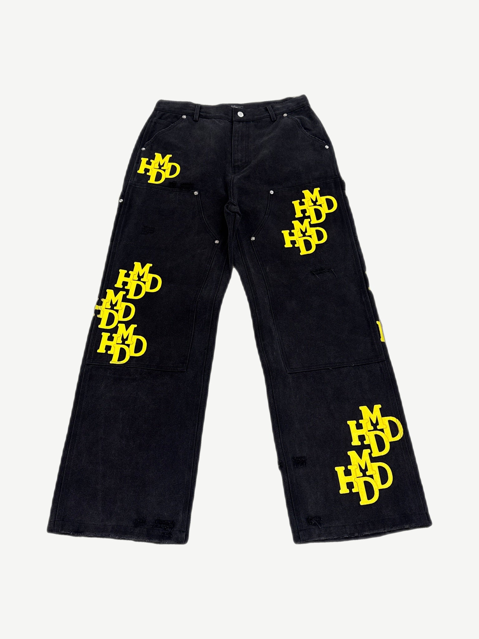 Happy Memories Don't Die HMDD black carpenter pants with yellow patches, utility loops and tool pockets, front