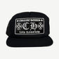 Chrome Hearts black Los Angeles CH trucker hat with embroidered CH cross logo and Los Angeles text panel.