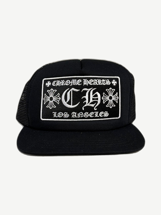 Chrome Hearts black Los Angeles CH trucker hat with embroidered CH cross logo and Los Angeles text panel.
