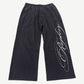 GV Gallery x Raspberry Hills black wide-leg sweatpants with white cursive script logo down leg.
