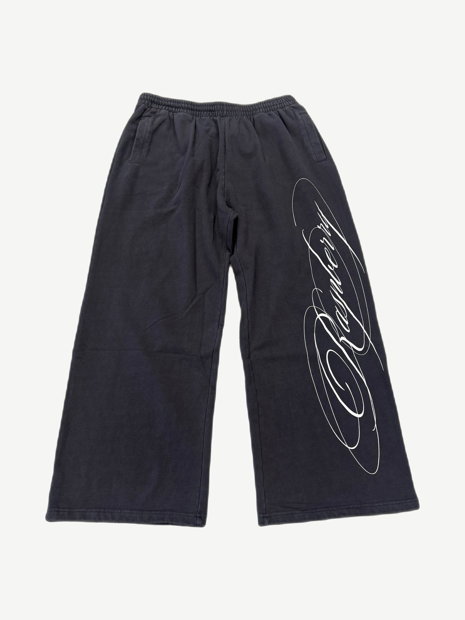 GV Gallery x Raspberry Hills black wide-leg sweatpants with white cursive script logo down leg.