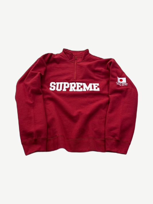 Supreme dark red half-zip pullover with white block logo on chest and Japanese flag patch on right sleeve