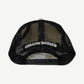 Rear view of Chrome Hearts eyechart trucker cap showing white mesh back panels and black snapback closure.