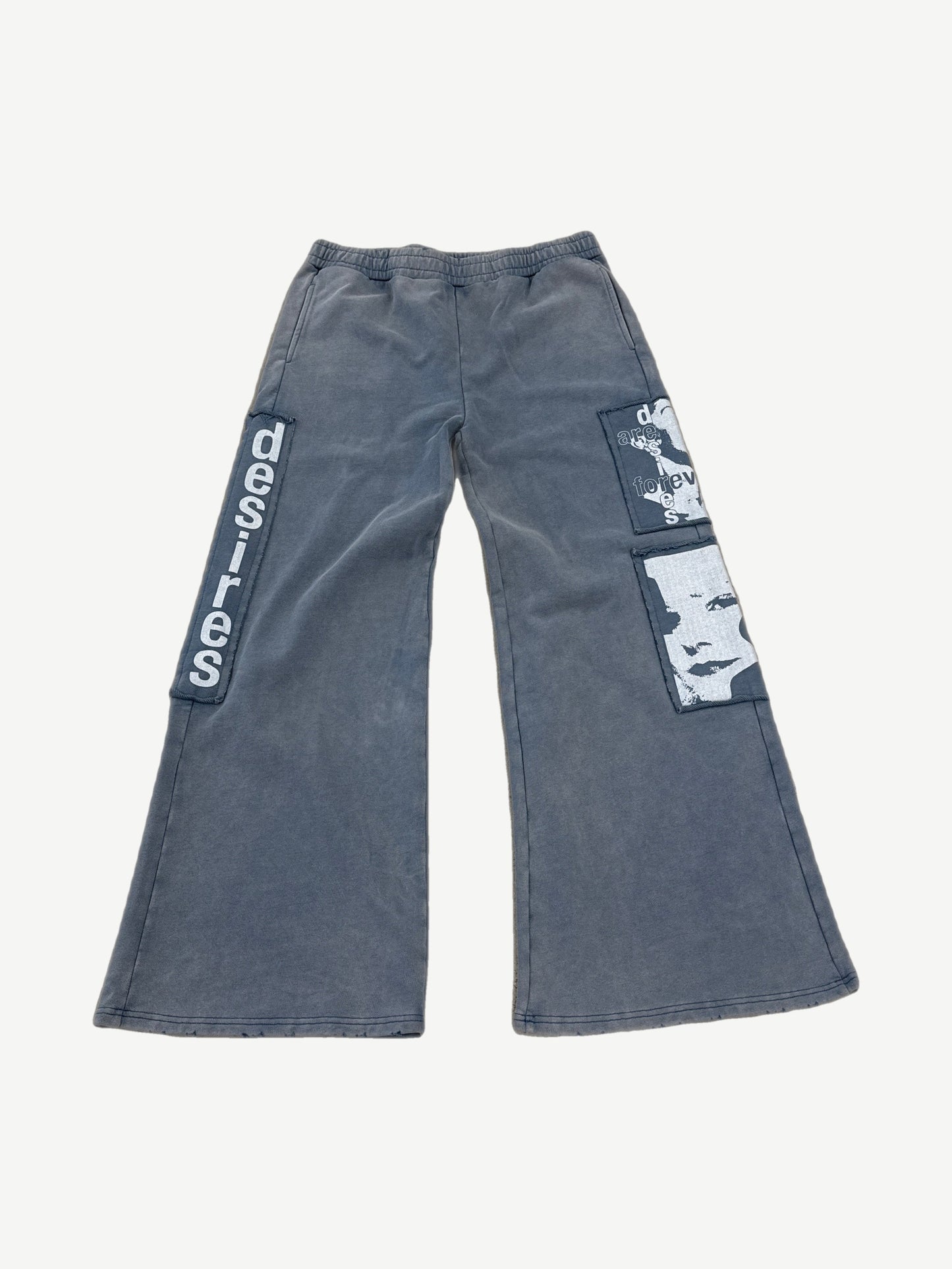Matiere De Desires blue cotton sweatpants front with elastic waist drawcord and tonal embroidered logo.