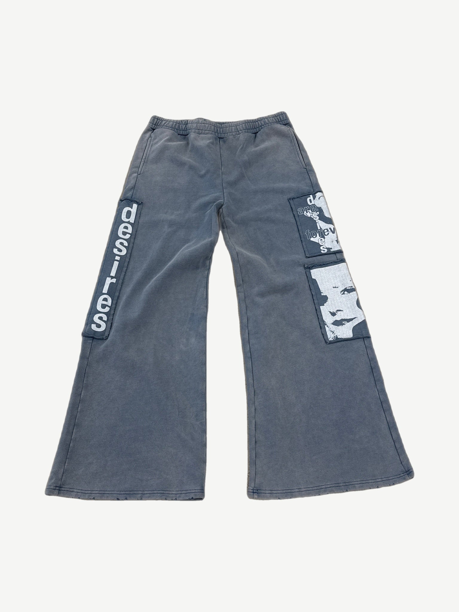 Matiere De Desires blue cotton sweatpants front with elastic waist drawcord and tonal embroidered logo.