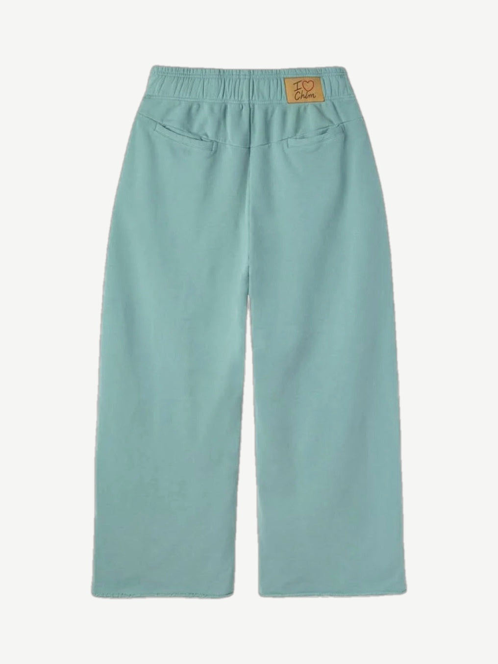 HMDD seafoam green organic sweatpants back view showing patch pocket and tapered cuffed leg silhouette