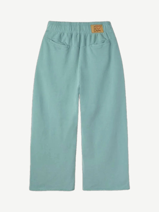 HMDD seafoam green organic sweatpants back view showing patch pocket and tapered cuffed leg silhouette