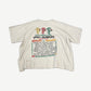 HMDD cream Rasta festival tee back view, faded vintage Rasta-colored back print on natural cotton body.