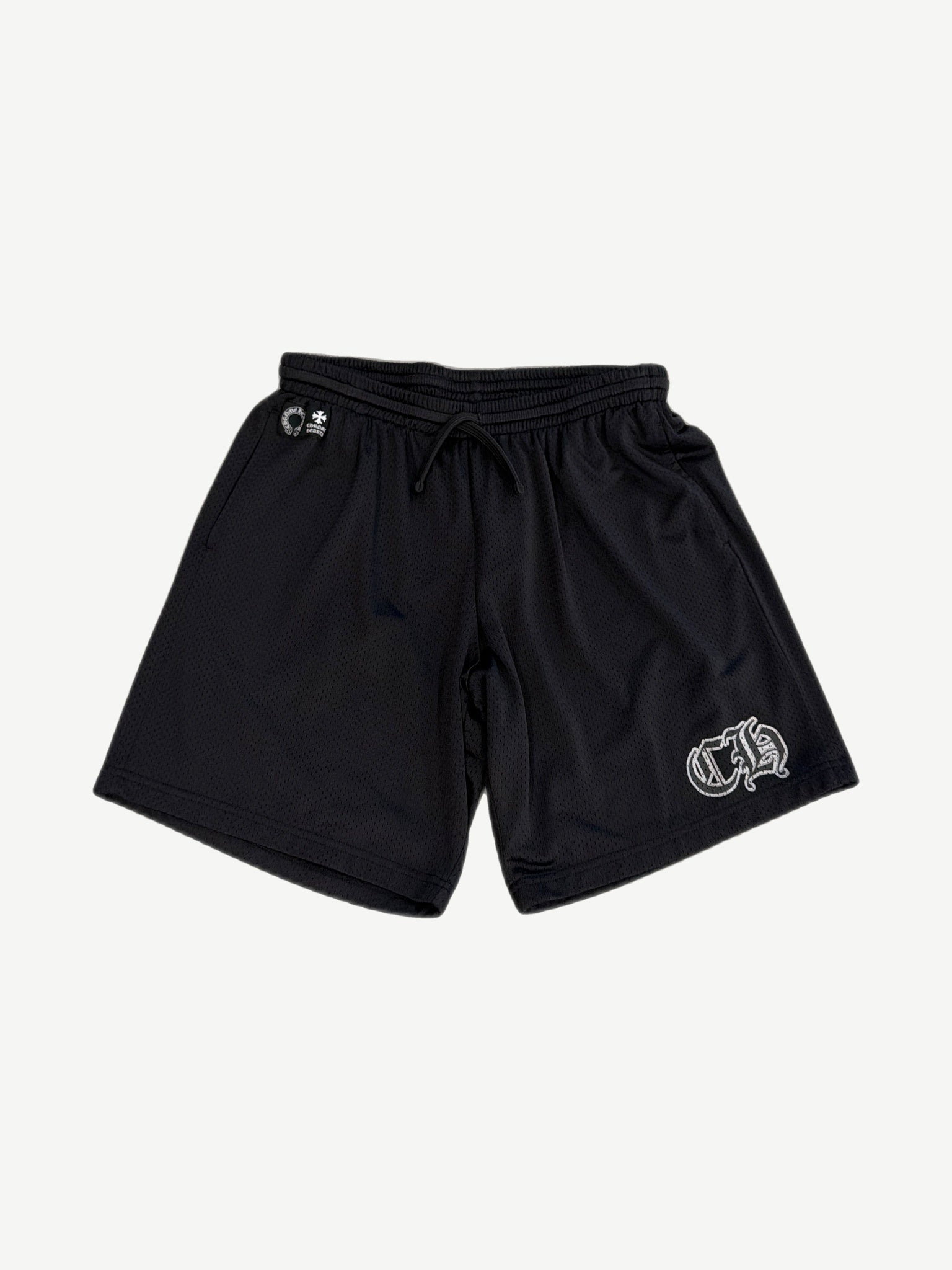 Chrome Hearts black mesh shorts front view with drawstring waist, horseshoe and cross logos, white gothic CH on left leg.