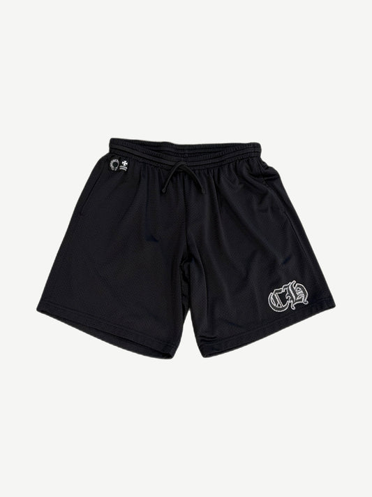 Chrome Hearts black mesh shorts front view with drawstring waist, horseshoe and cross logos, white gothic CH on left leg.