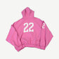 Balenciaga pink distressed polo zipup back view with large 22 print and matching number on the sleeve.