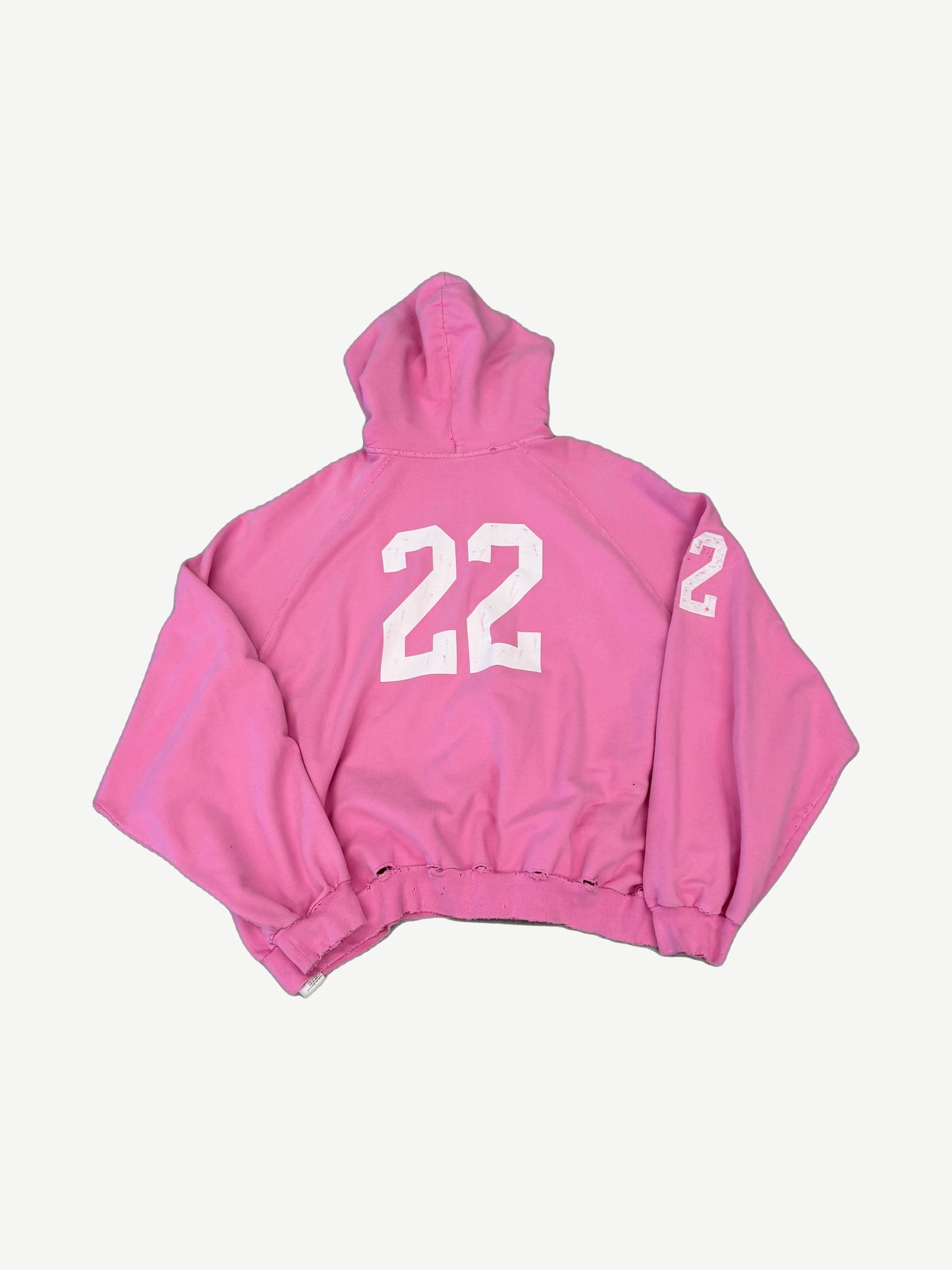 Balenciaga pink distressed polo zipup back view with large 22 print and matching number on the sleeve.
