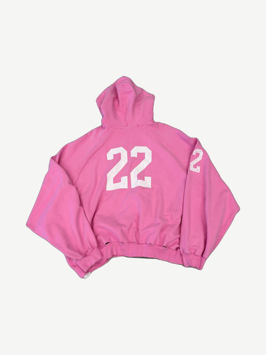 Balenciaga pink distressed polo zipup back view with large 22 print and matching number on the sleeve.