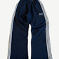 Balenciaga navy baggy sweatpants front with white triple side stripes and Loop Sports Icon swoosh logo