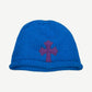 Chrome Hearts royal blue chunky cashmere knit beanie with purple leather cross dagger patch on front.