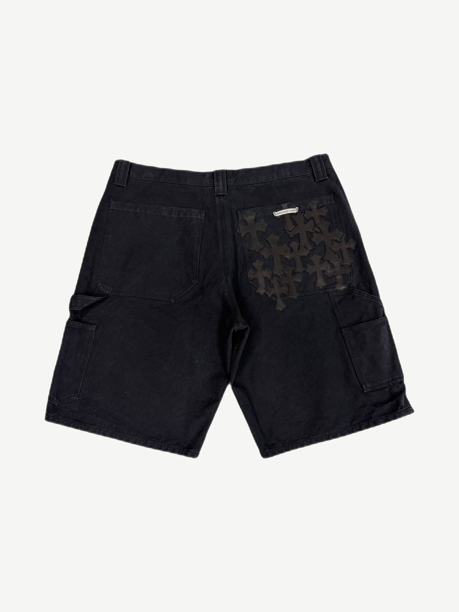 Chrome Hearts black carpenter shorts back view flooded with black leather cross patches on right pocket and panel