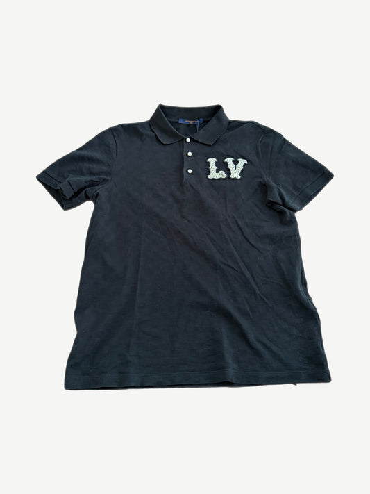 Louis Vuitton black polo with pearl LV monogram chest patch, tonal checkerboard texture and three button placket.