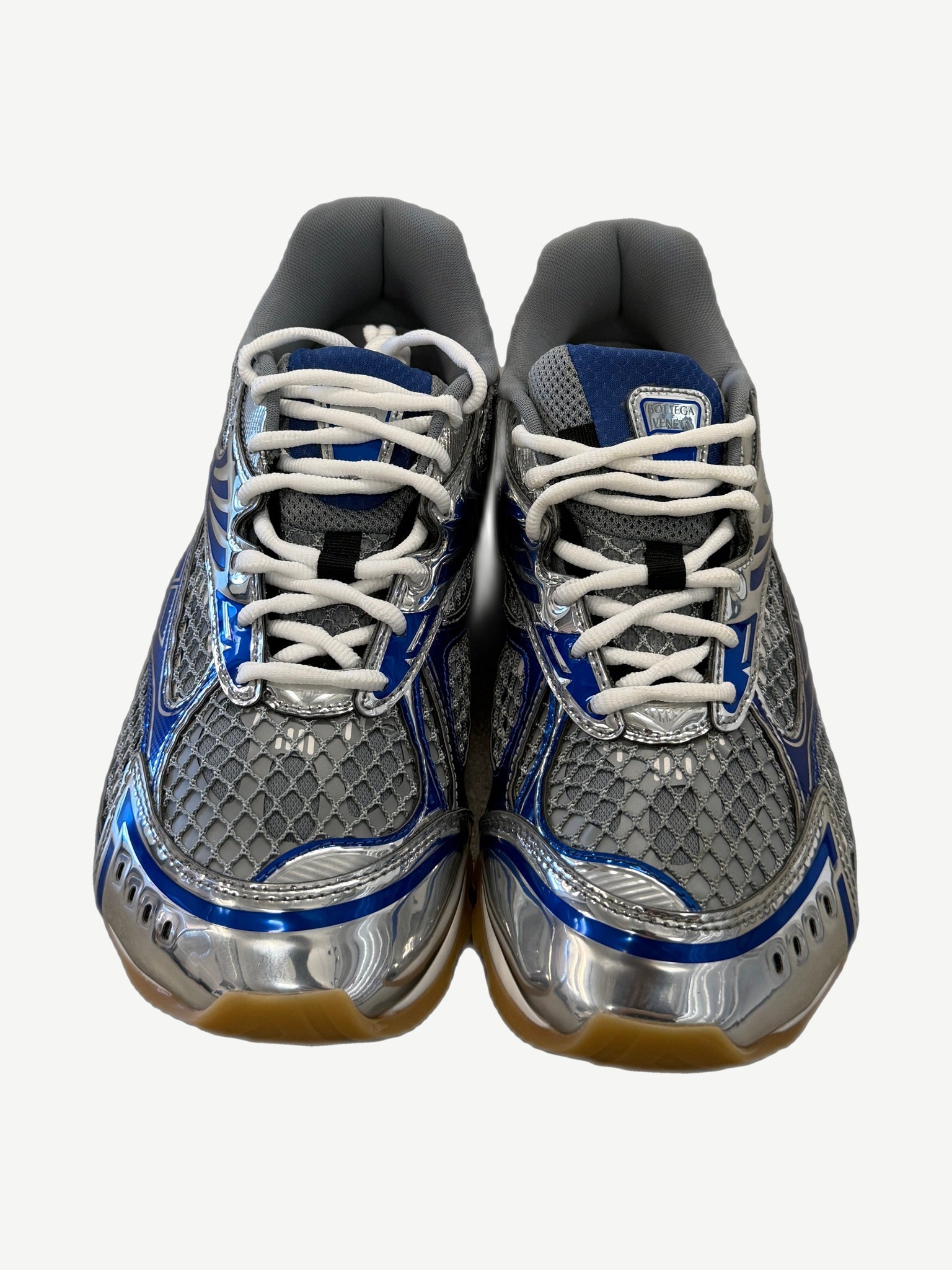 Bottega Veneta Orbit sneakers front view, silver mesh upper with white laces and blue trim, gum sole