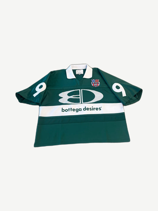 Bottega Desires green futbol jersey with white chest band, shield crest patch and ribbed polo collar