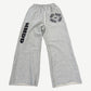 HMDD gray sweatpants with studded HMDD leg graphic and clustered circular logo emblems down the thigh.