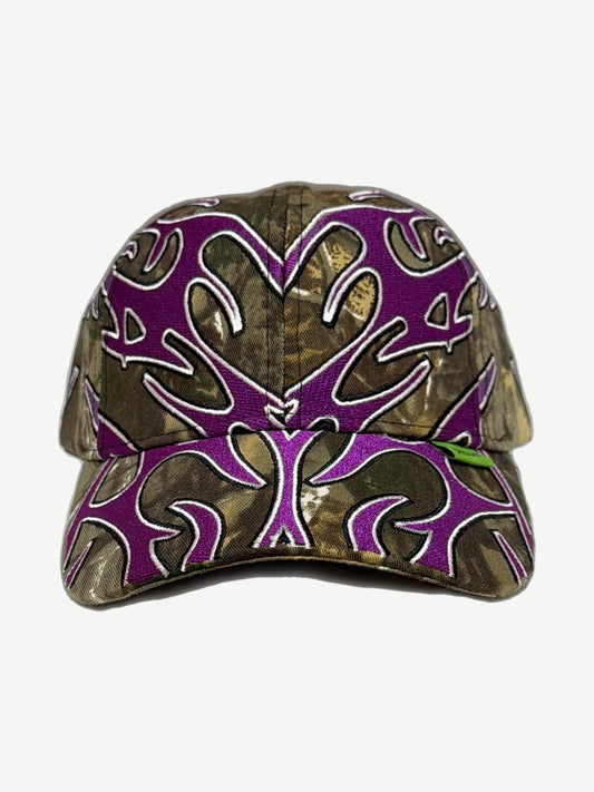 Living Product Man Vs Nature dad hat in tree-bark camo with purple embroidered antler flame motif