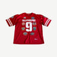 Supreme red Championships football jersey front view with embroidered chest graphics and athletic mesh fabric