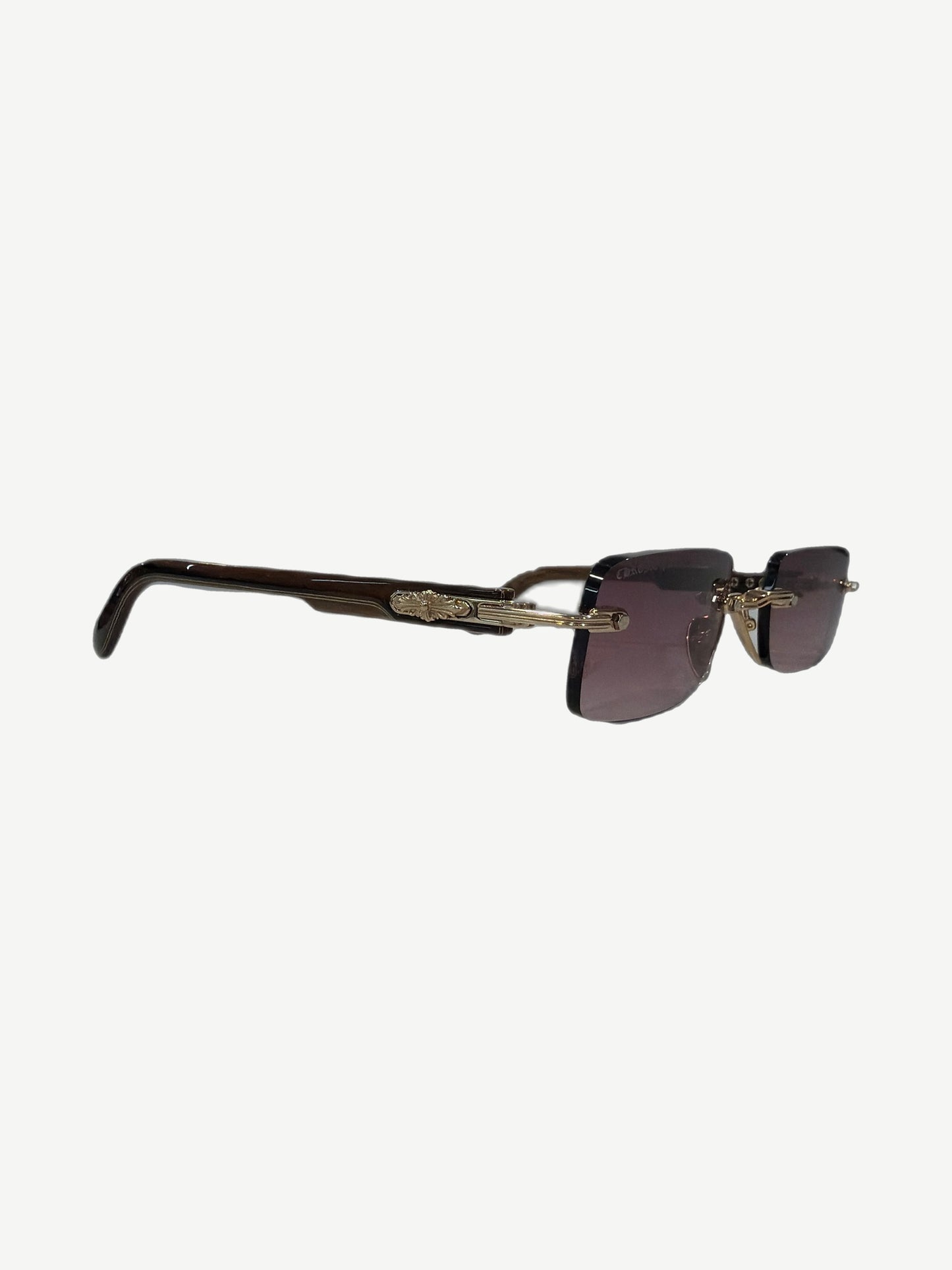 Chrome Hearts Wood Deep 1 rimless sunglasses side view with brown horn temples and engraved gold scroll arms