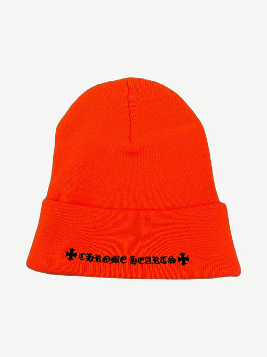 Chrome Hearts orange knit beanie back view showing ribbed cuff and black gothic logo placement.