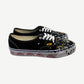 Gallery Dept Art That Kills black Vans Authentic sneakers with paint-splattered toe and red foxing print.