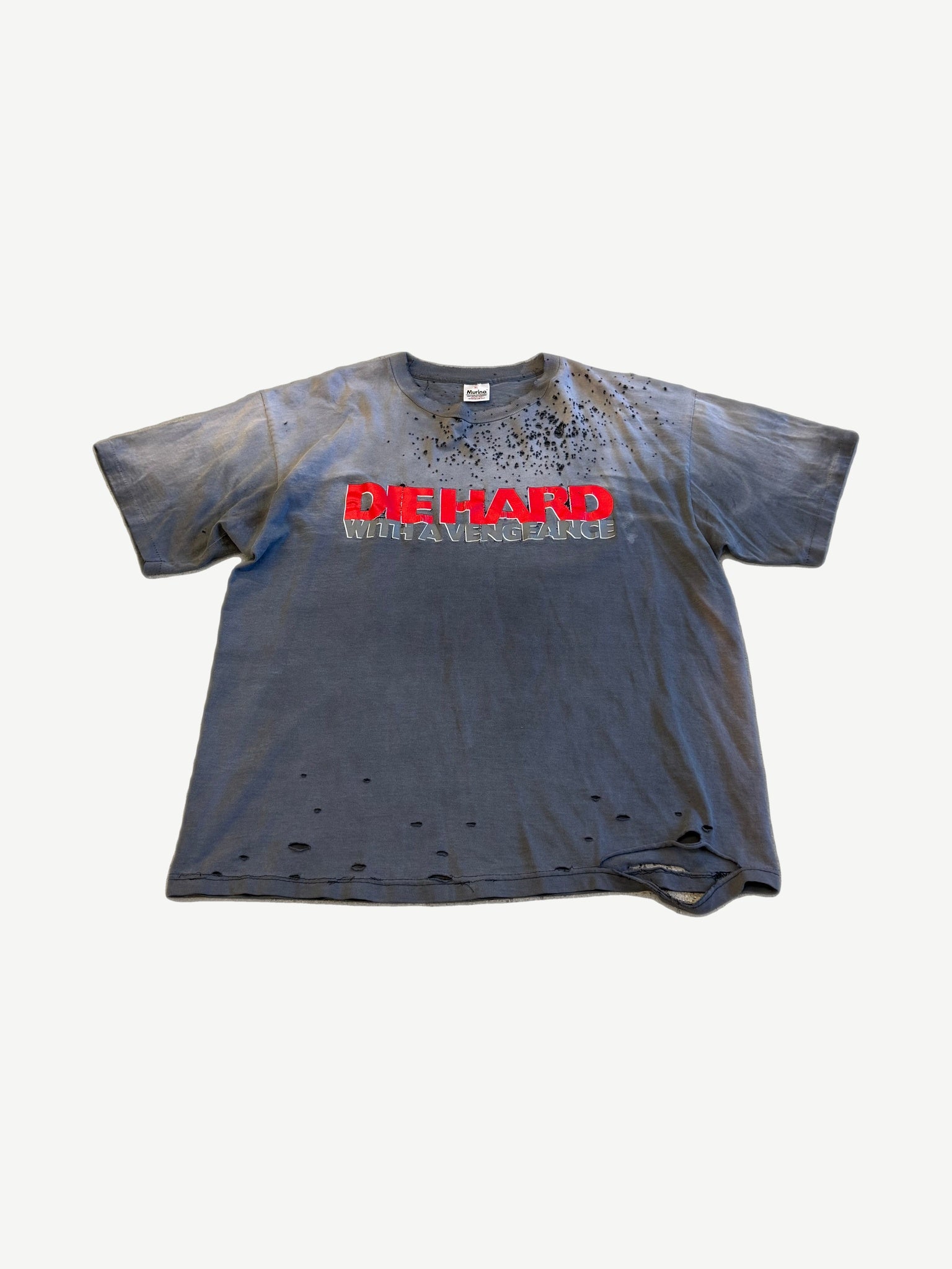 Vintage thrashed gray Die Hard With a Vengeance tee with red logo, paint splatter and heavy moth holes