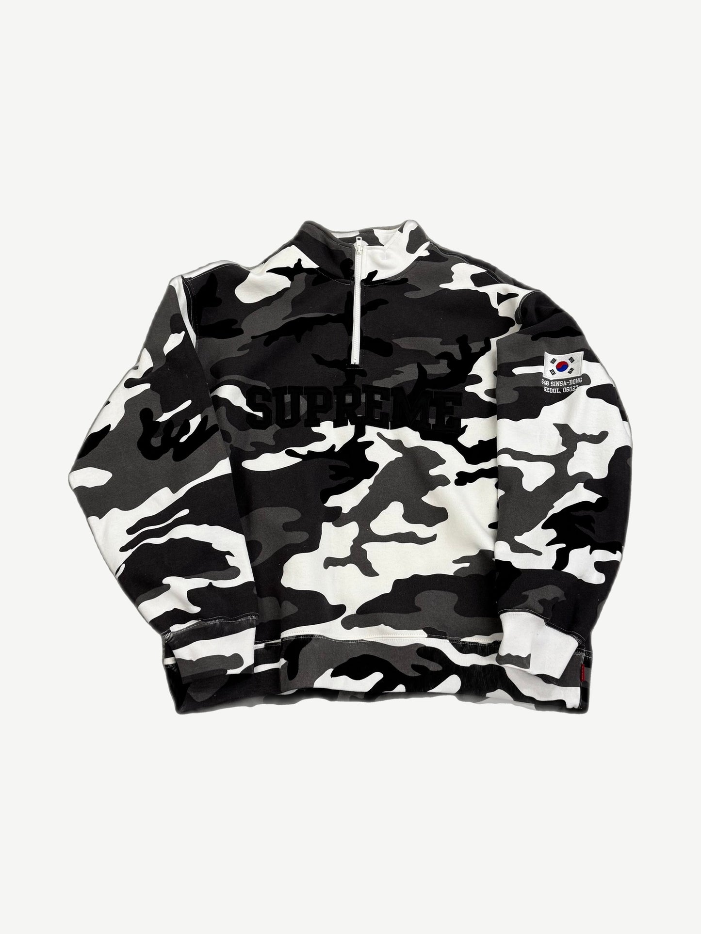 Supreme black and white snow camo half-zip pullover front with arc logo and Korean flag Sinsa-Dong Seoul patch