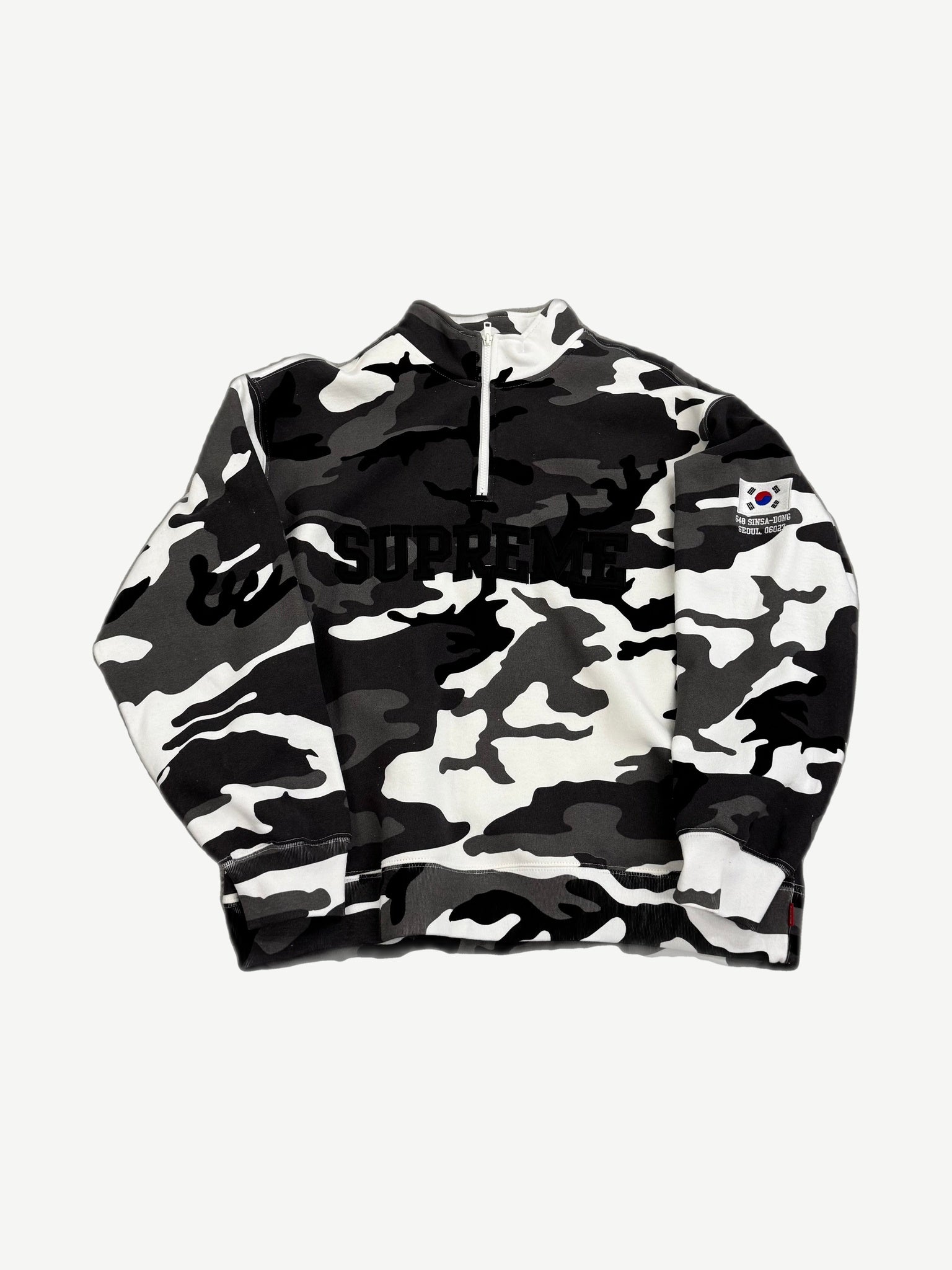 Supreme black and white snow camo half-zip pullover front with arc logo and Korean flag Sinsa-Dong Seoul patch