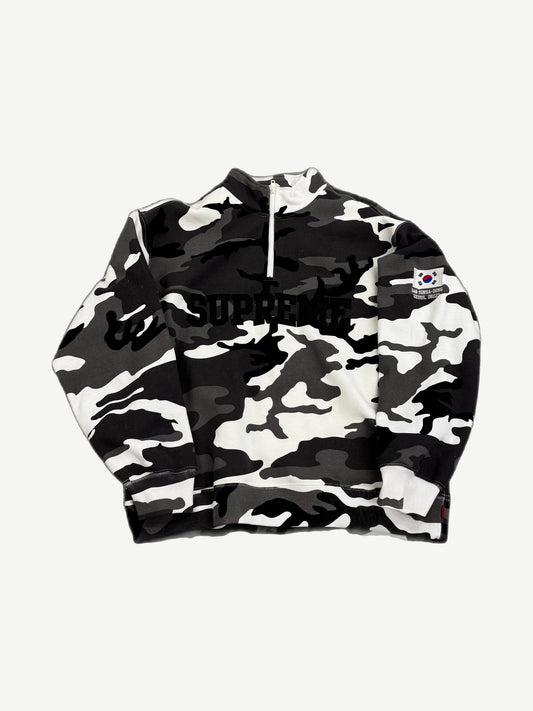 Supreme black and white snow camo half-zip pullover front with arc logo and Korean flag Sinsa-Dong Seoul patch