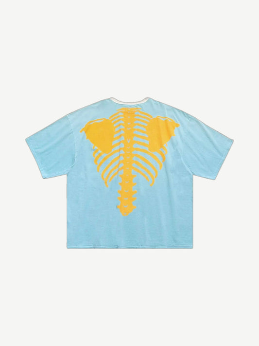 Kapital Bone 2 Tone tee back showing light blue body with bold yellow skeleton ribcage and spine graphic.