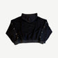Back of HMDD Flower Studded black hoodie showing rhinestone flower embellishments scattered on sleeves.