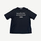 Acne Studios black tee with white Stockholm 1996 distressed logo print centered on chest, front view.