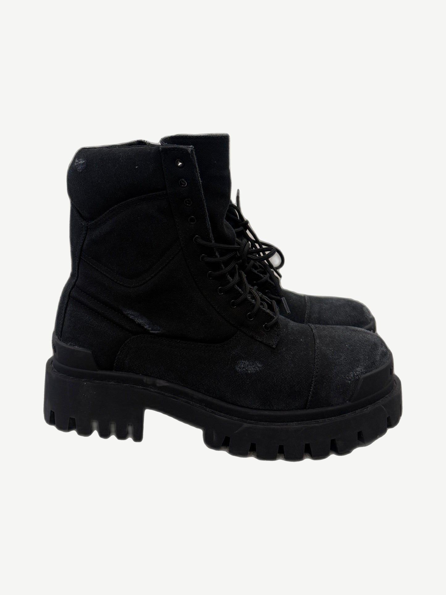Balenciaga Combat Strike boots in chunky black canvas with lace-up military-style upper and exaggerated lugged sole.
